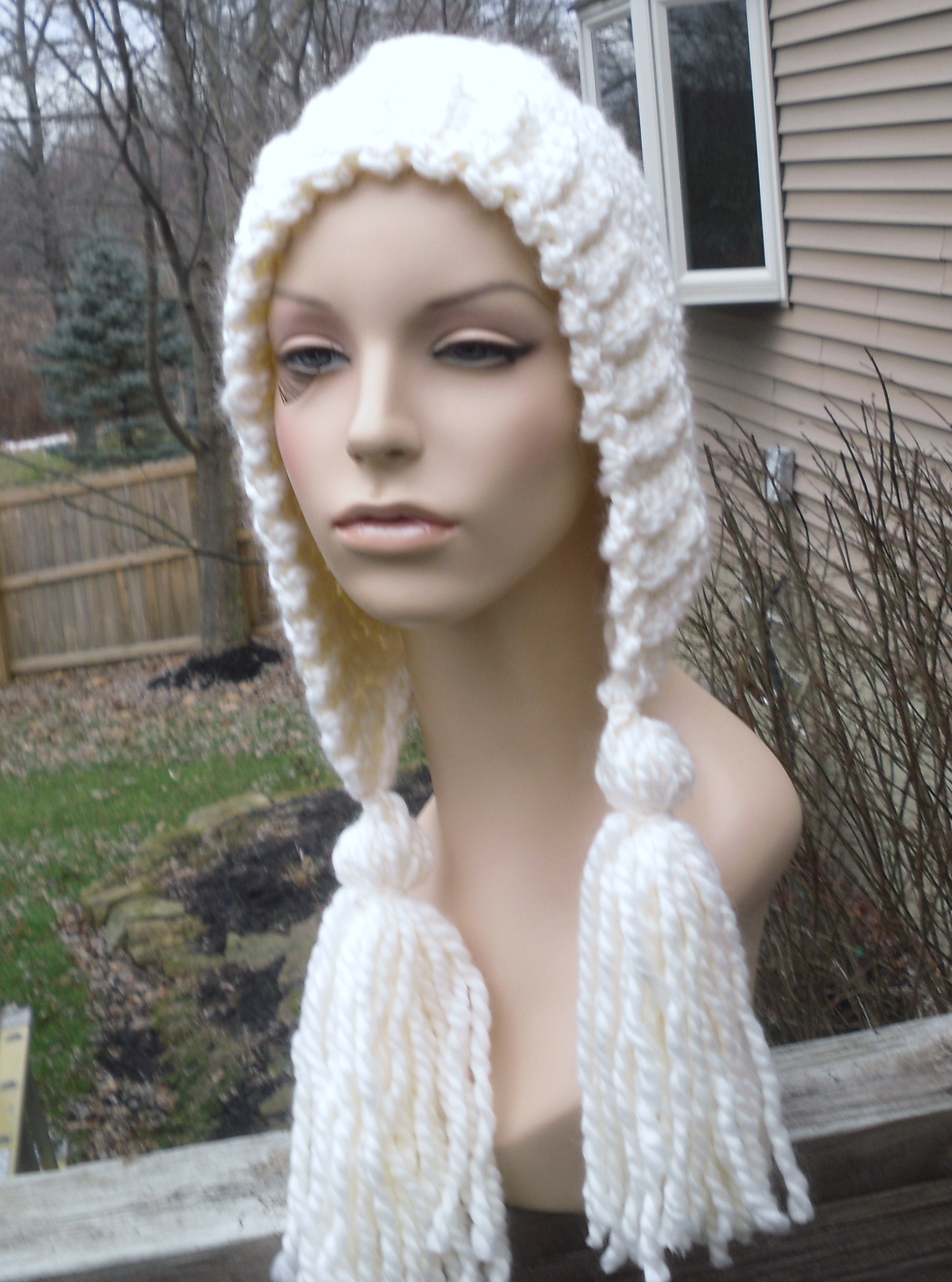 A mannequin wearing a white handwoven head scarf